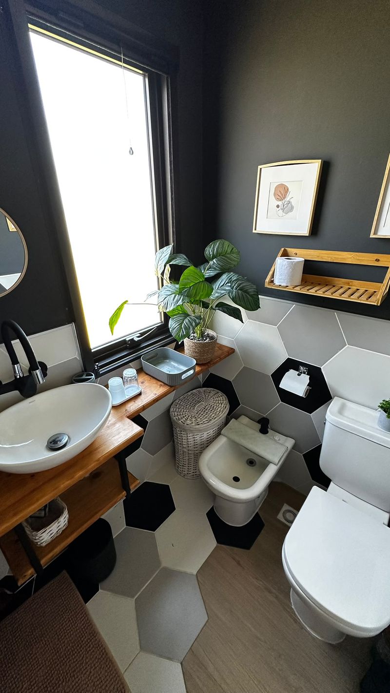 Baño completo con lavabo de diseño y ventana al campo